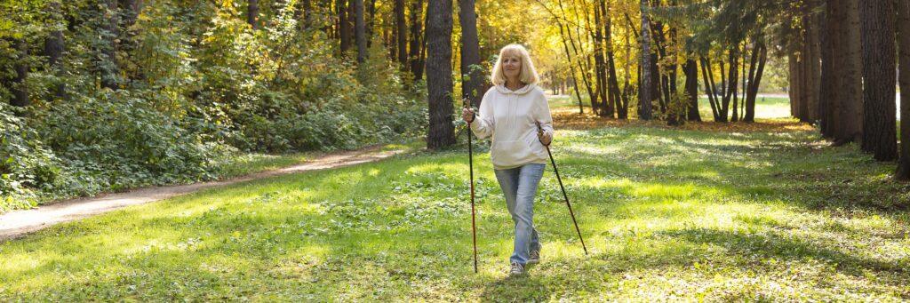 older woman trekking outside nature